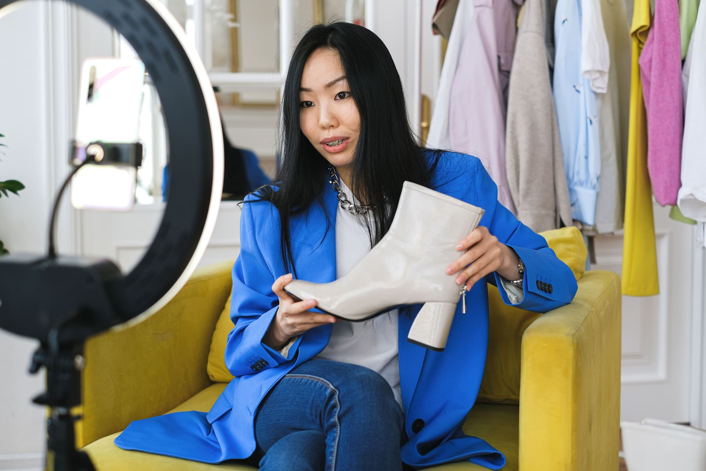 A creator filming a product presentation to camera under a ring light.